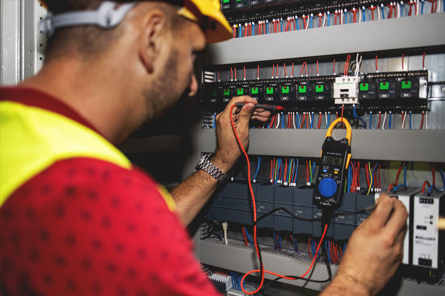electrician testing electrical connections with meter