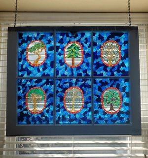 Forest Canopy Through a Kaleidoscope (hung against window to show stained glass mosaic effect) by Sandy Thapsem