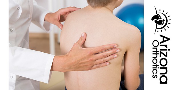 doctor checking the spine of a male patient