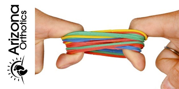 lots of rubber band being pulled apart by opposing pointer fingers