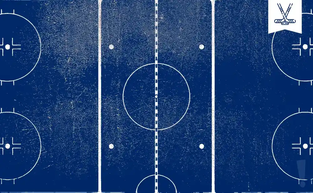 An overhead view of a blue hockey rink with white markings, featuring a central face-off circle and two corner face-off circles.