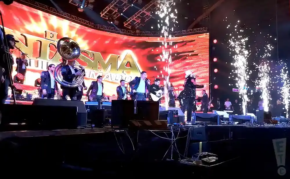 A band performs on stage with fireworks.