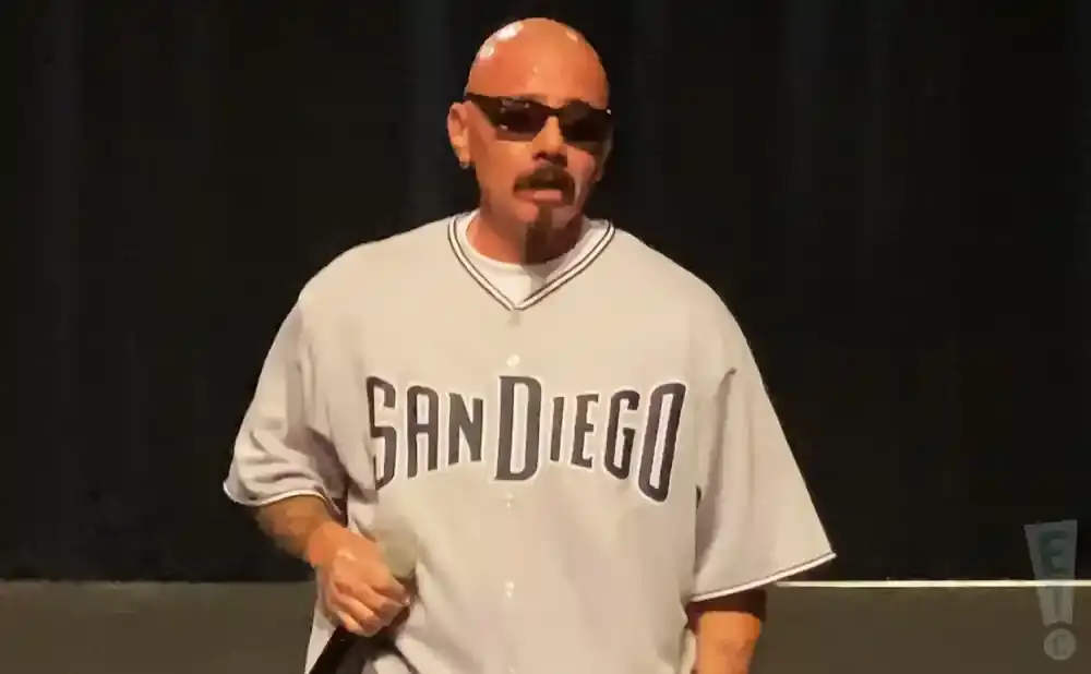 A bald man with a mustache and goatee, wearing sunglasses and a 