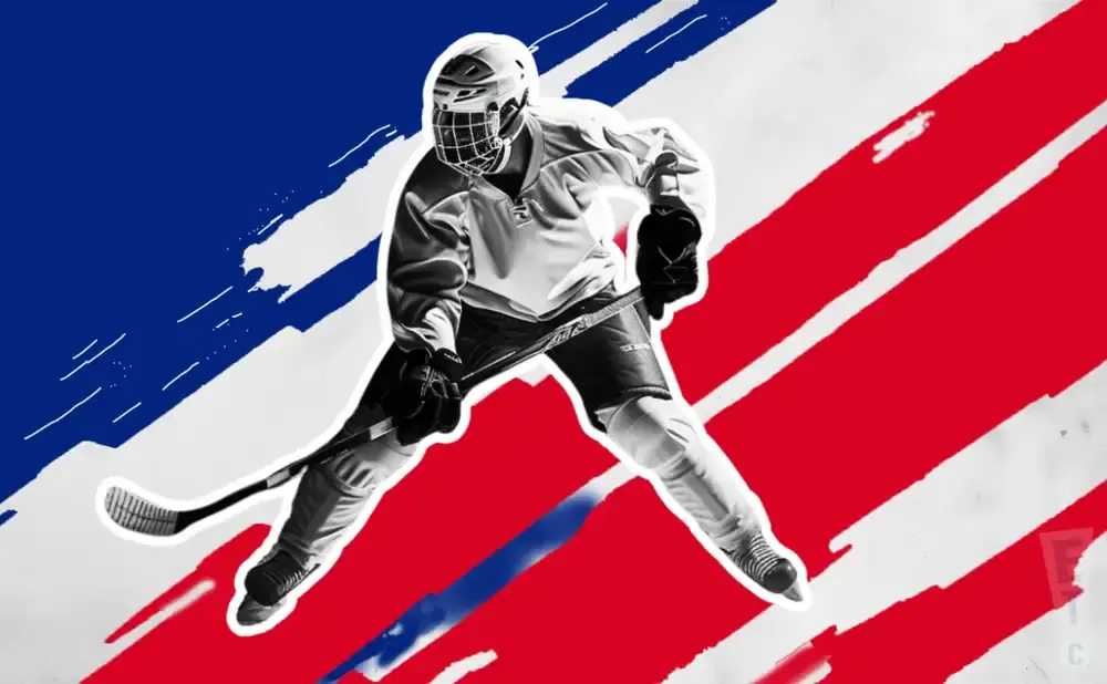 A hockey player in a white uniform skates with a stick against a red, white, and blue background.