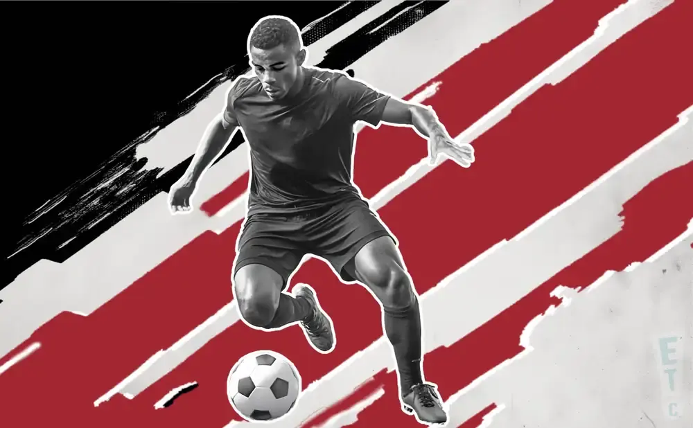 A soccer player dribbles a ball against a red and white striped background.