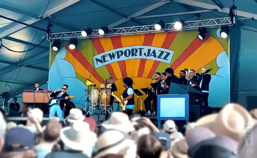 A jazz band performs on stage in front of a 