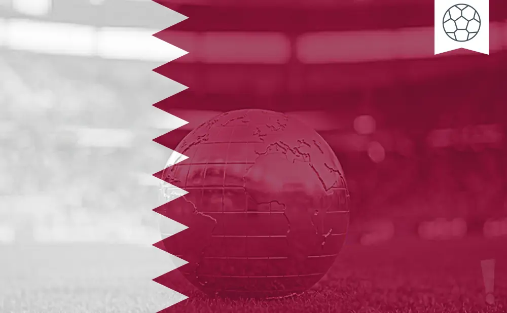 A globe on a soccer field with the Qatar flag overlay.