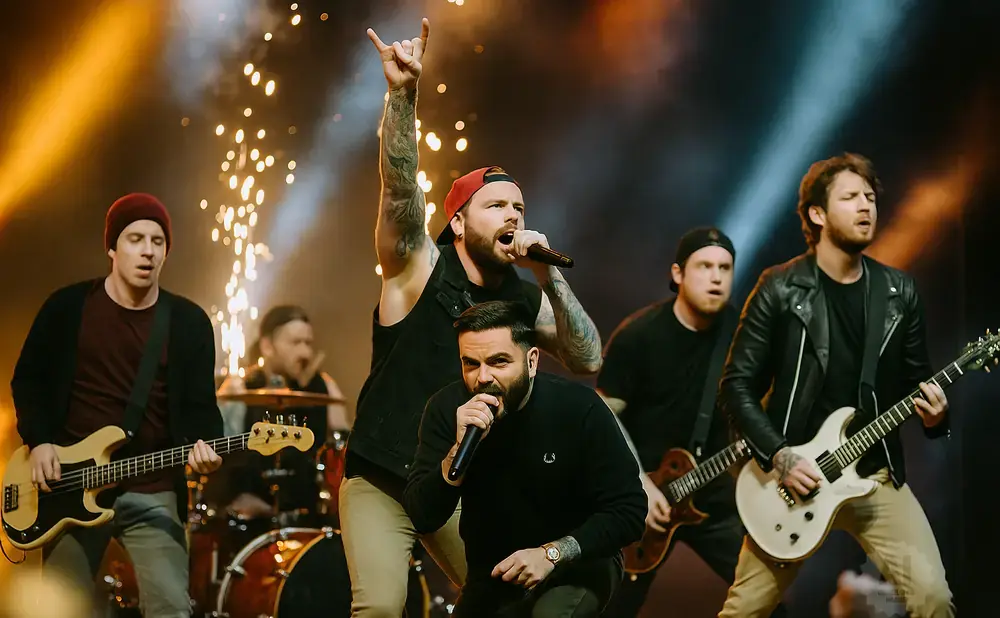 A band performs on stage with pyrotechnics, the lead singer holding his hand up in a rock-and-roll gesture.