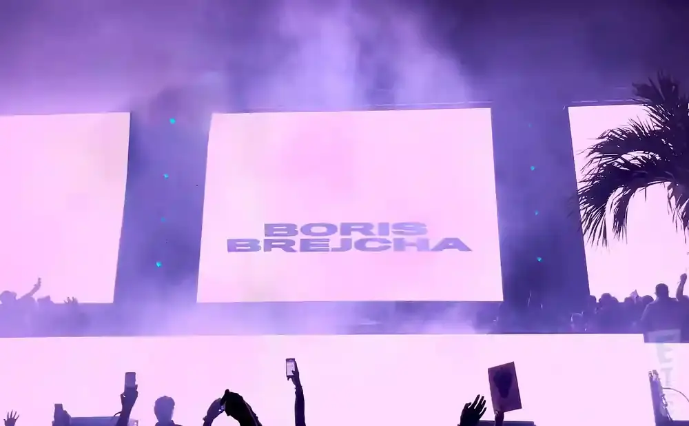 A large screen at a concert displays 