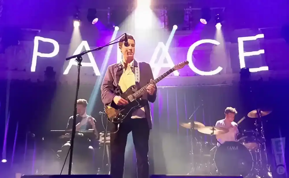 A band plays on stage under a large 