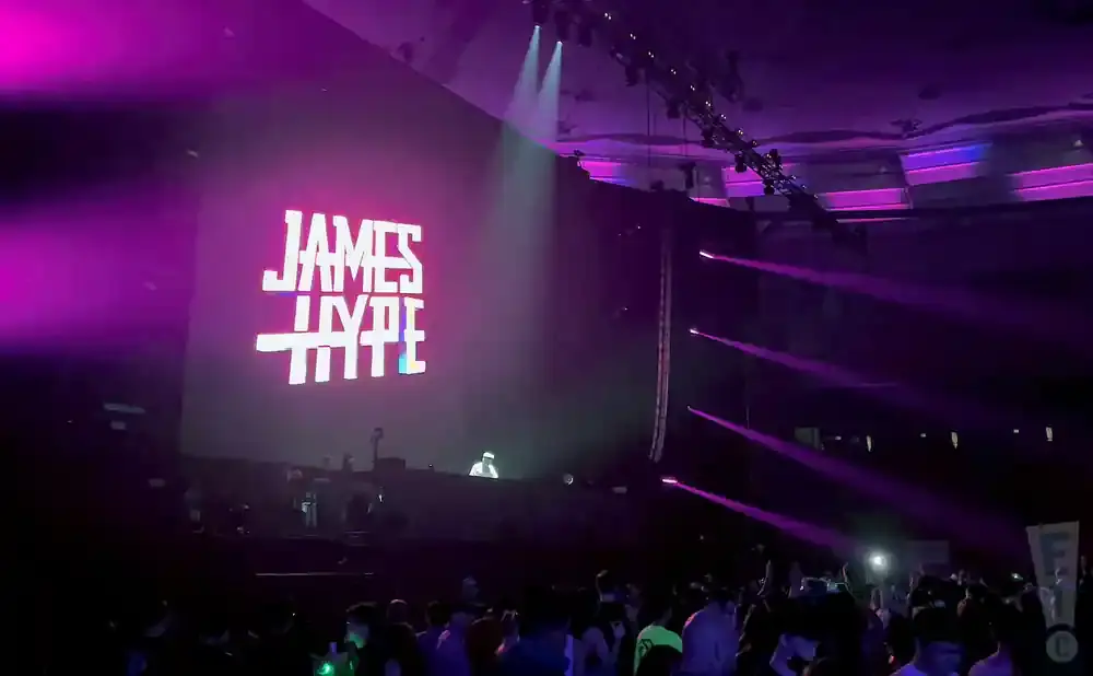 A DJ performs on stage with 