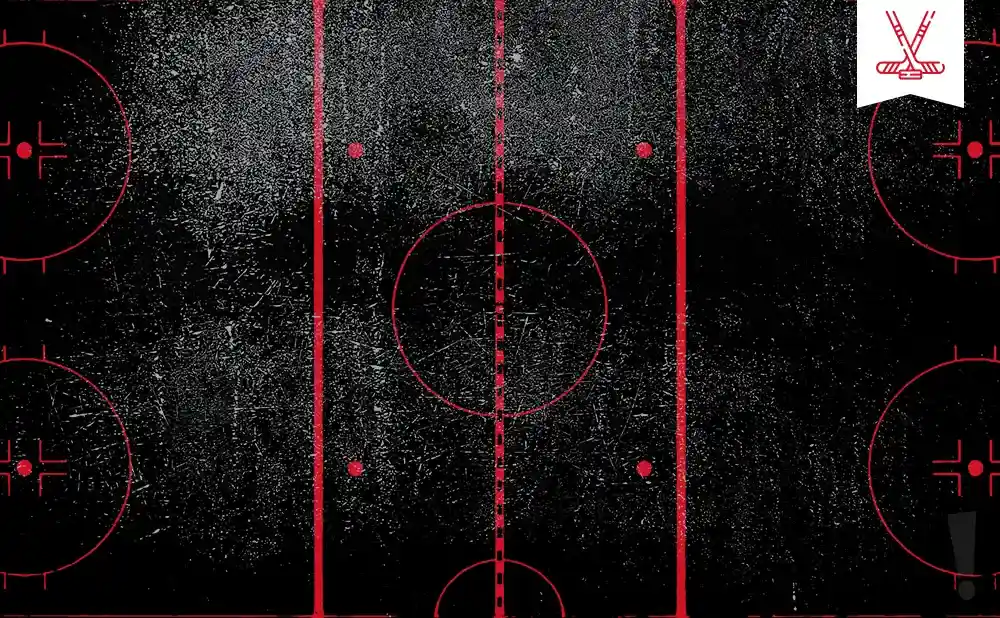 A hockey rink with red markings on a textured black surface.