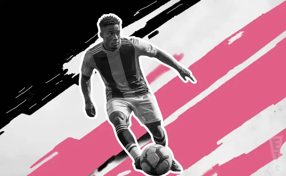 A Black male soccer player dribbles a ball on a pink and black abstract background.