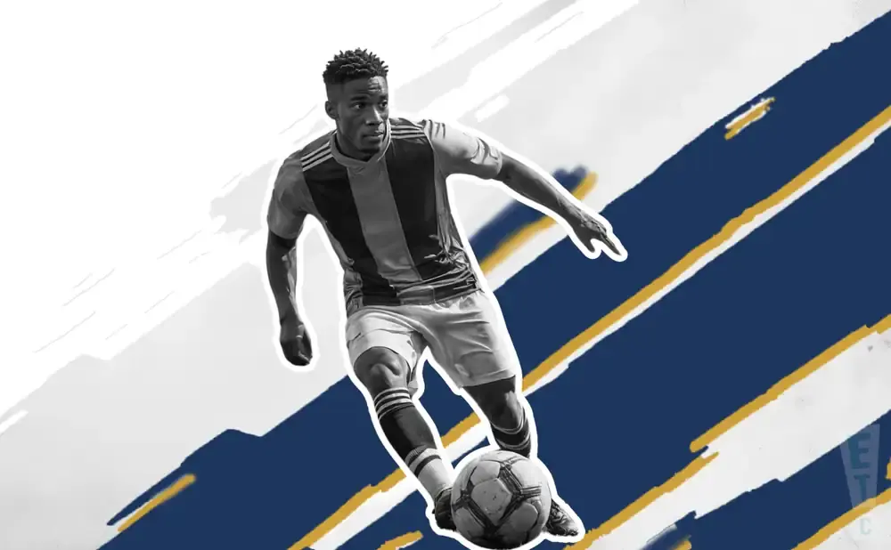 A Black male soccer player dribbles a ball against a blue and white abstract background.