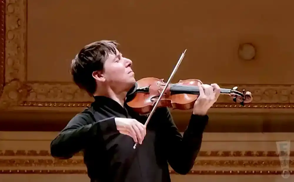 A violinist plays his instrument during a performance.