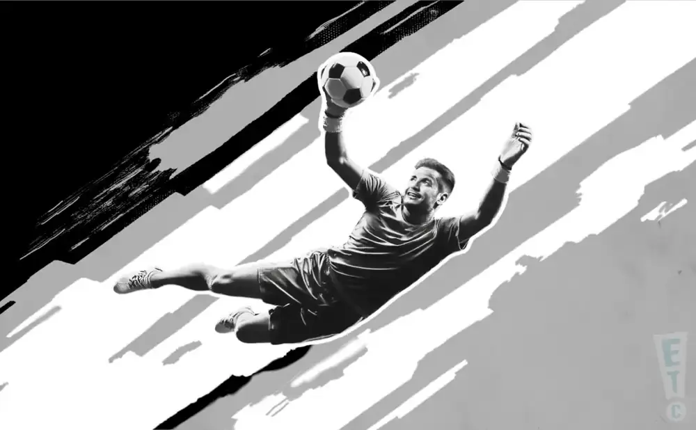 A black and white image of a soccer goalie diving to catch a ball.