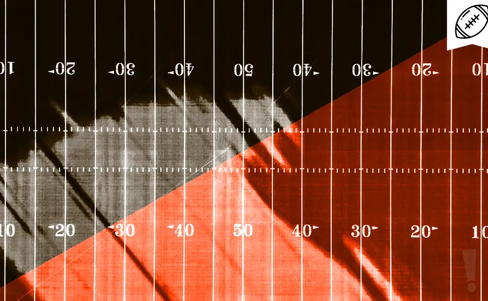 American football field with orange and dark sections, marked with yard lines and numbers.