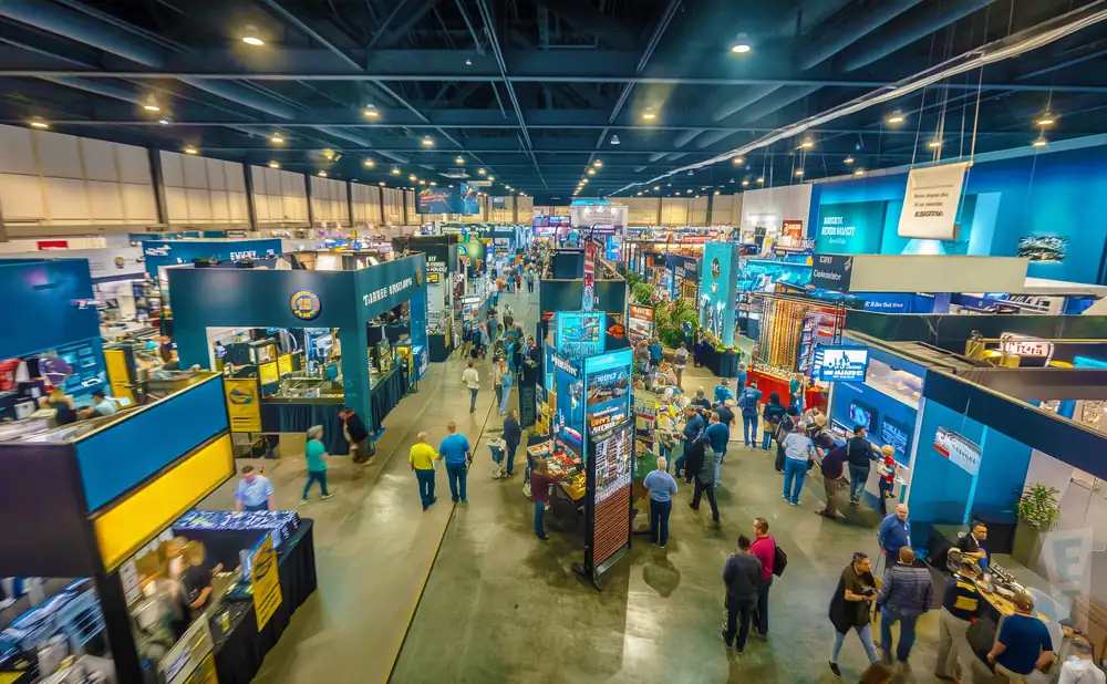 An aerial view of a crowded trade show with booths and attendees.