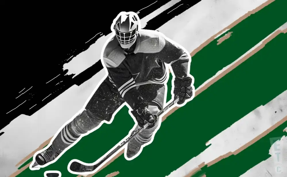 A hockey player in a dark uniform skates with a stick.