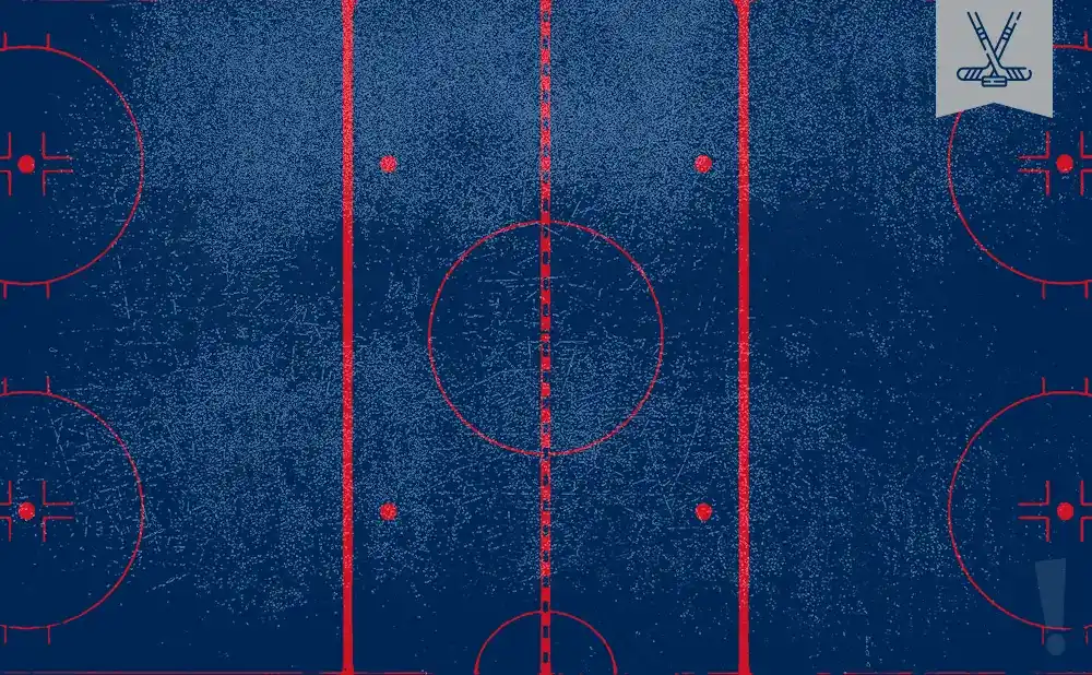 An overhead view of a blue ice hockey rink with red markings, including circles and lines.