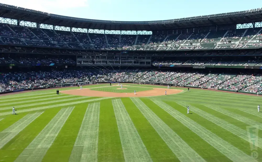 An aerial view of a baseball stadium with players on the field and spectators in the stands.