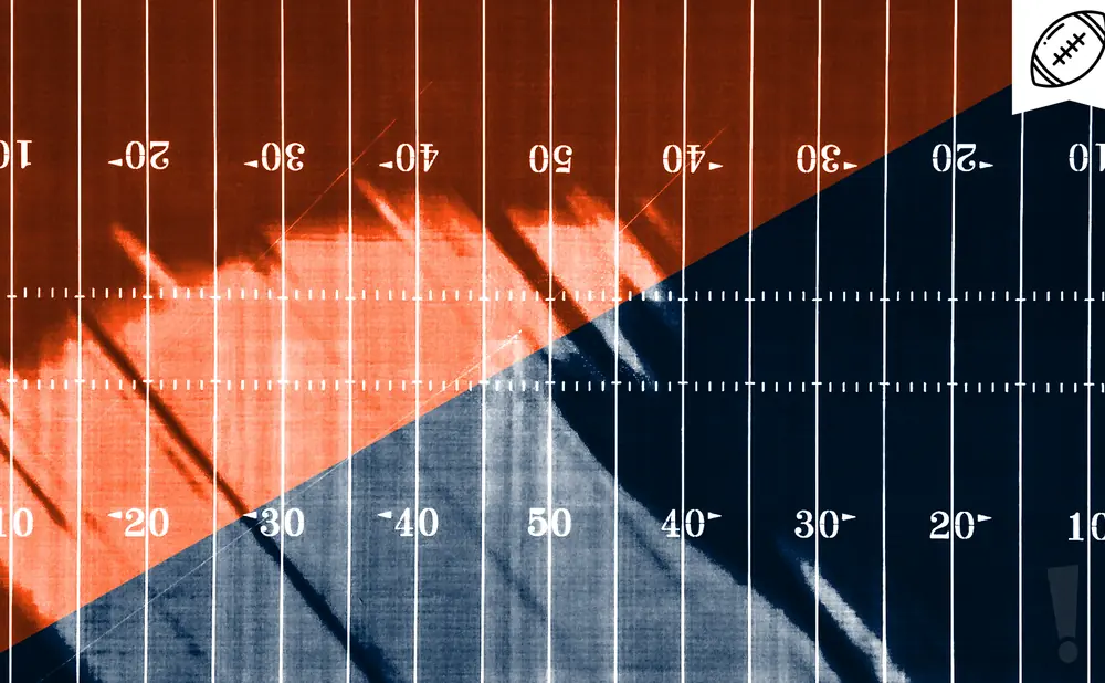 A split football field, orange on the left and navy blue on the right, with yard markers.