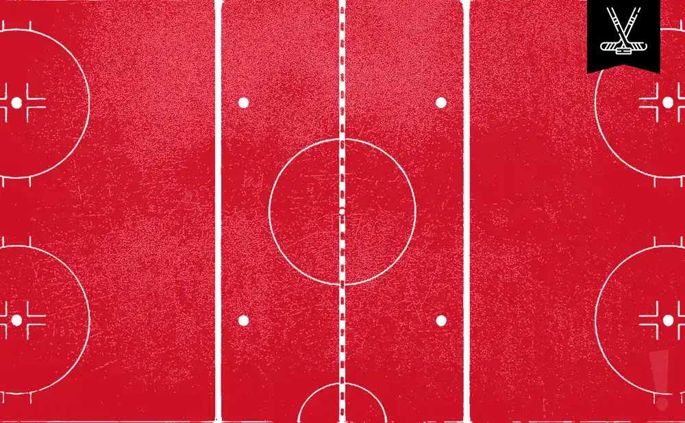 Red ice hockey rink with white markings, including face-off circles and center ice line.