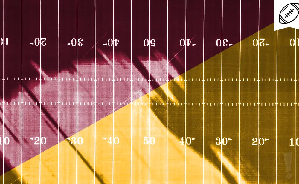 Football field marked with yard lines in maroon and gold, split diagonally.