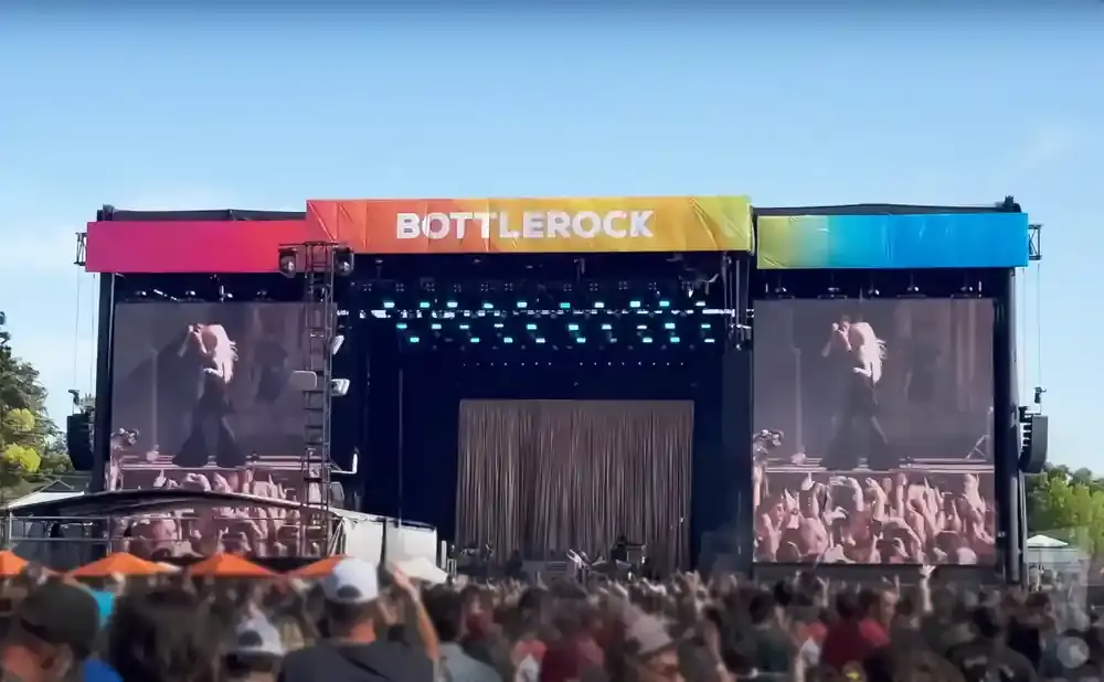 Bottlerock festival stage with screens showing a blonde performer and a crowd.