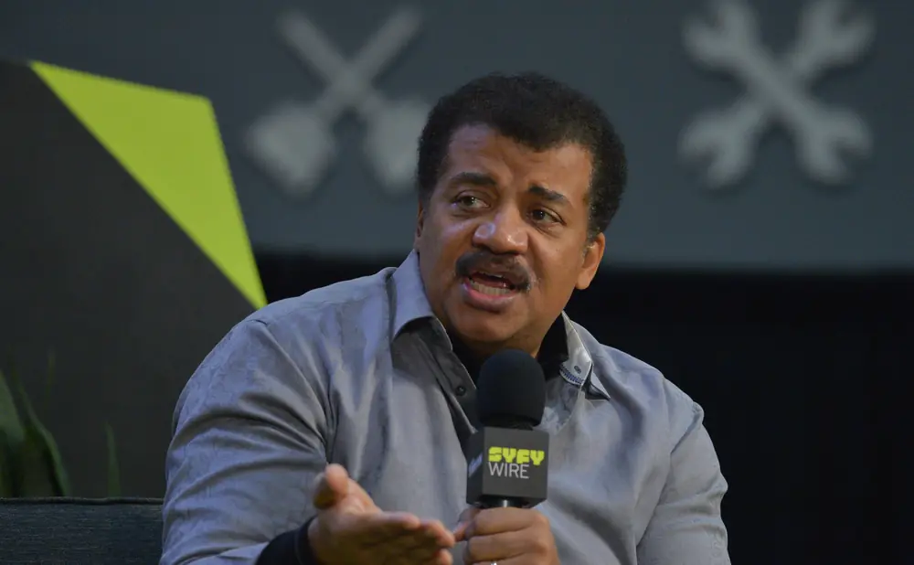 Neil deGrasse Tyson speaks into a 