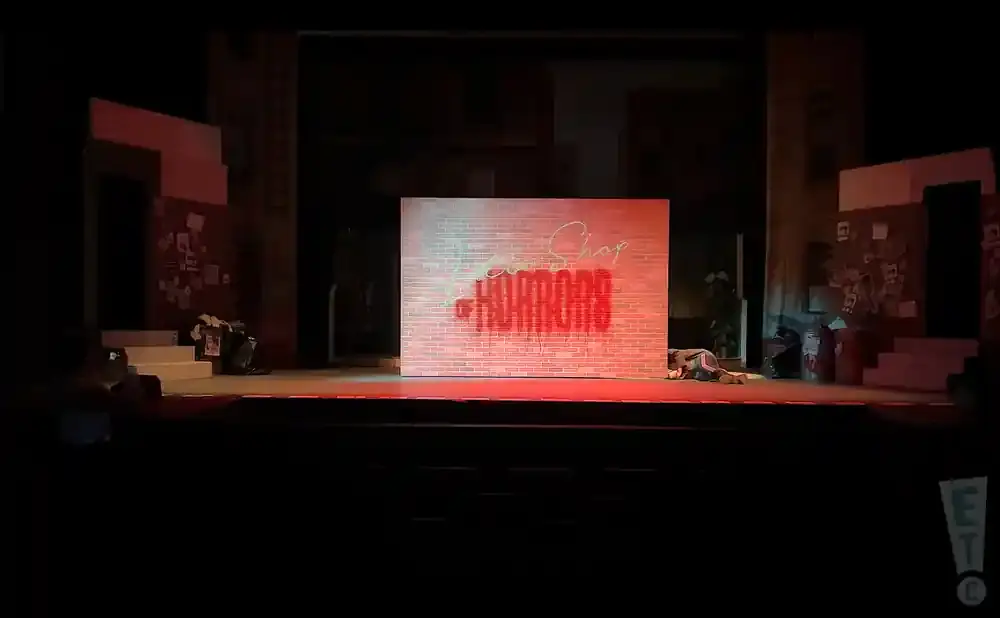 A stage with a brick wall that says 