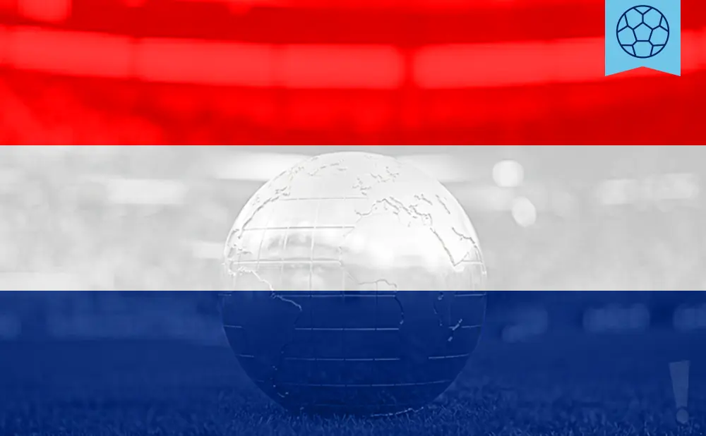 A glass globe rests on grass, superimposed on a flag with red, white, and blue stripes.