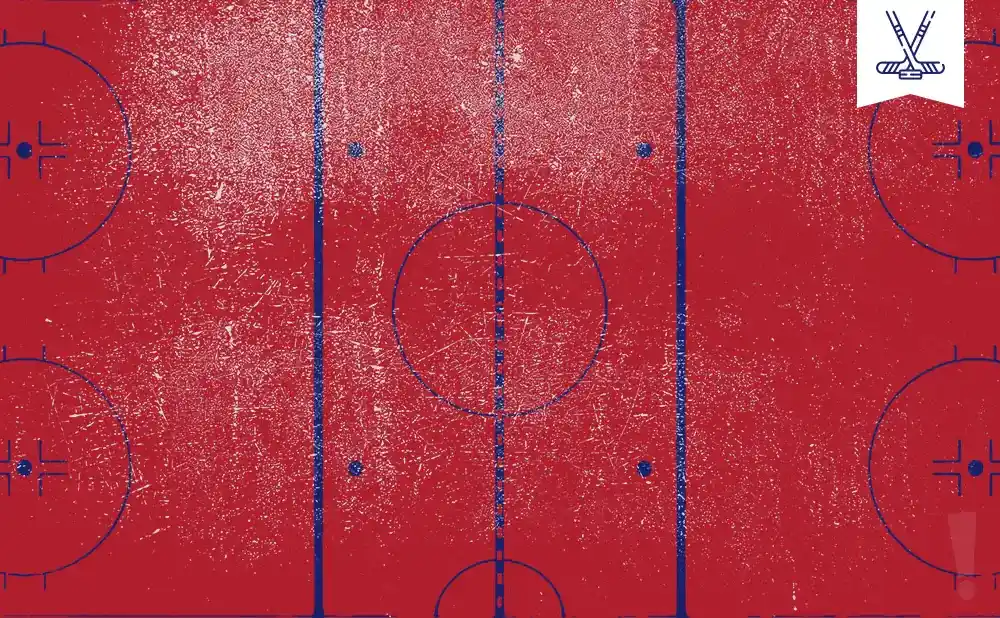 Red hockey rink with blue lines and markings, and a small white banner with crossed hockey sticks.