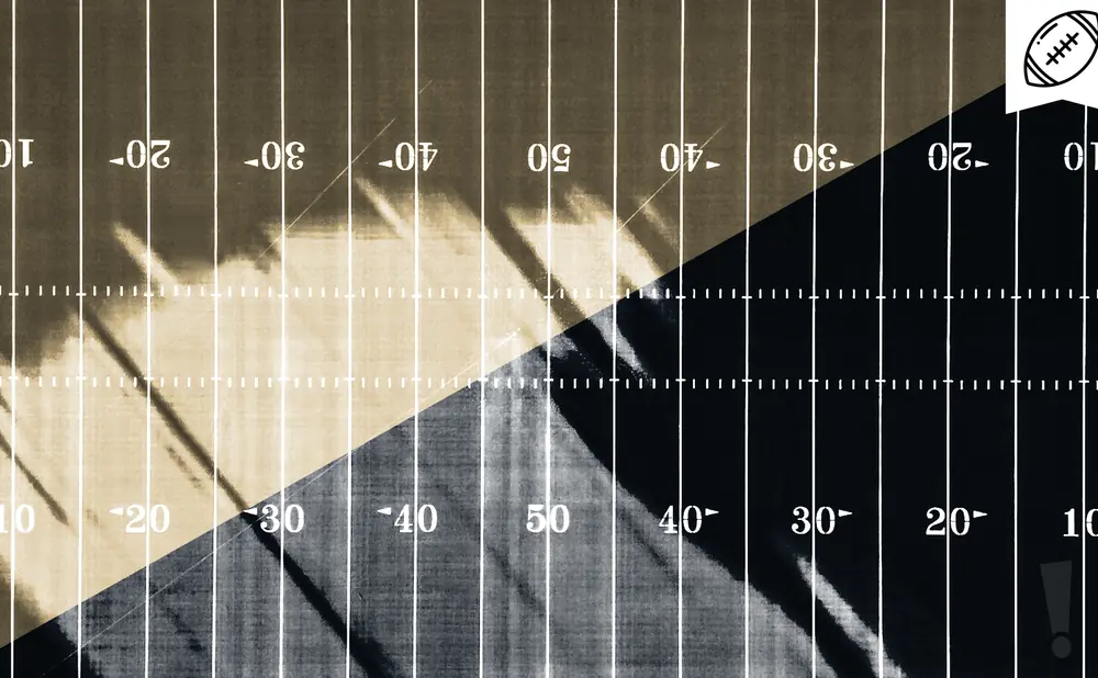 An overhead view of a football field with yard lines and numbers.