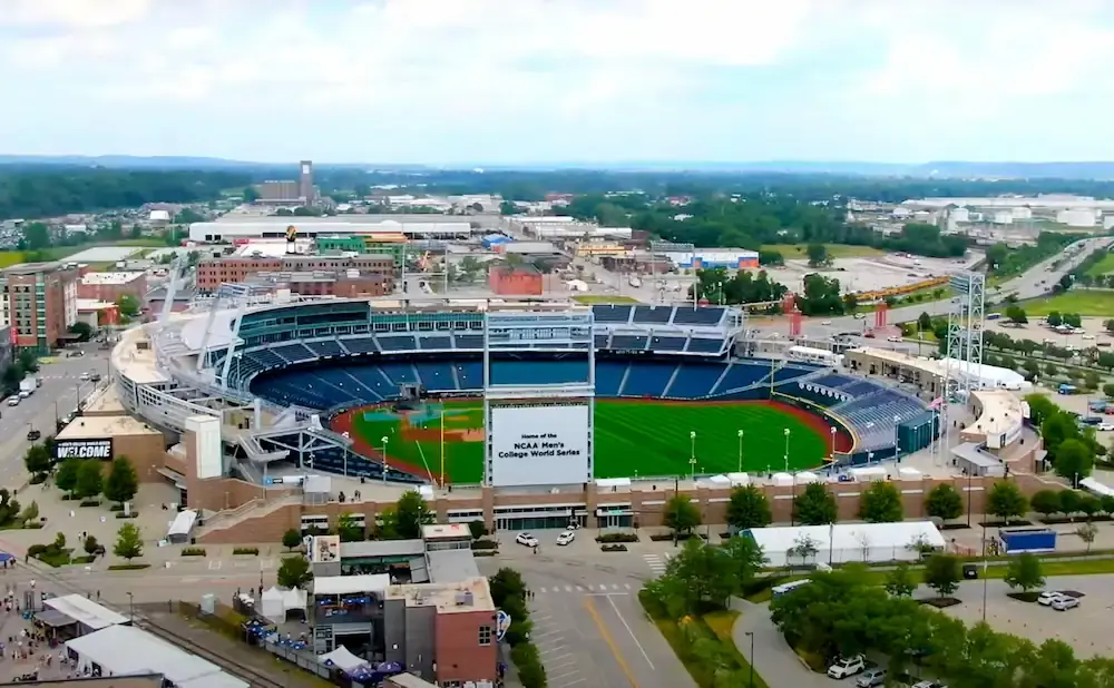 Aerial view of a baseball stadium with a large scoreboard displaying 