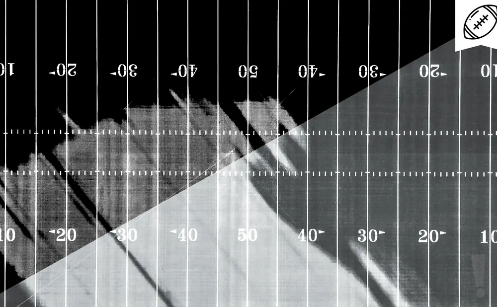 Football field with yard lines and numbers, black and white with a diagonal overlay.