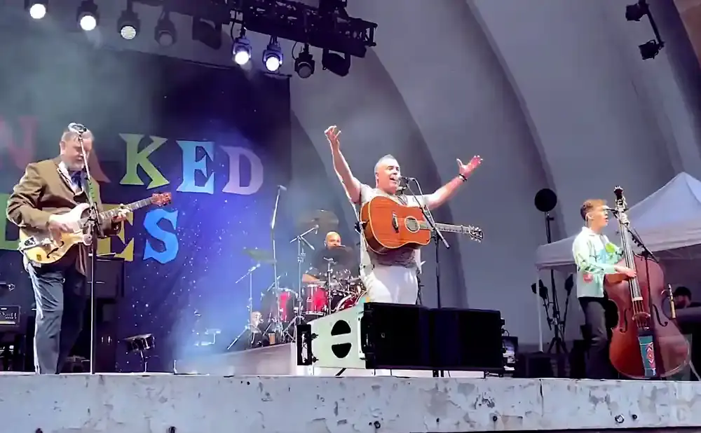 A band performs on stage with a 
