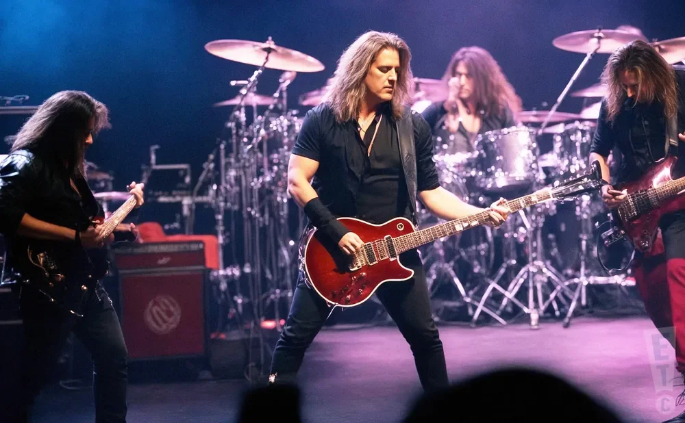 A rock band performs on stage with guitars and drums.