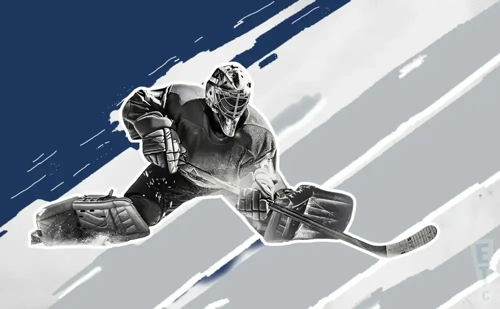 A hockey goalie in a split crouch, ready to make a save.