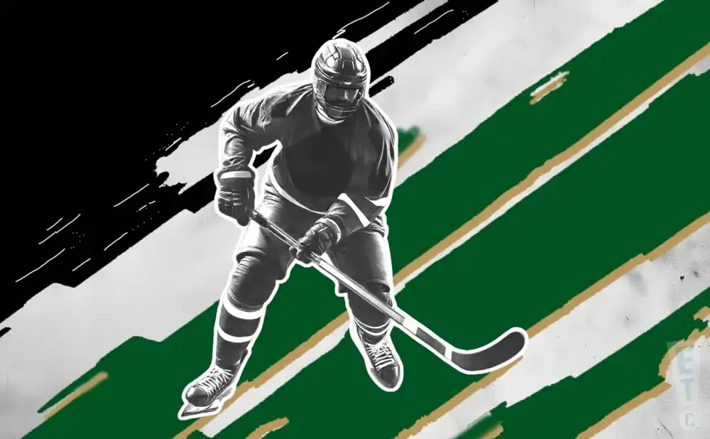 A hockey player in a black and white uniform skates with a stick on a background of green and white stripes.