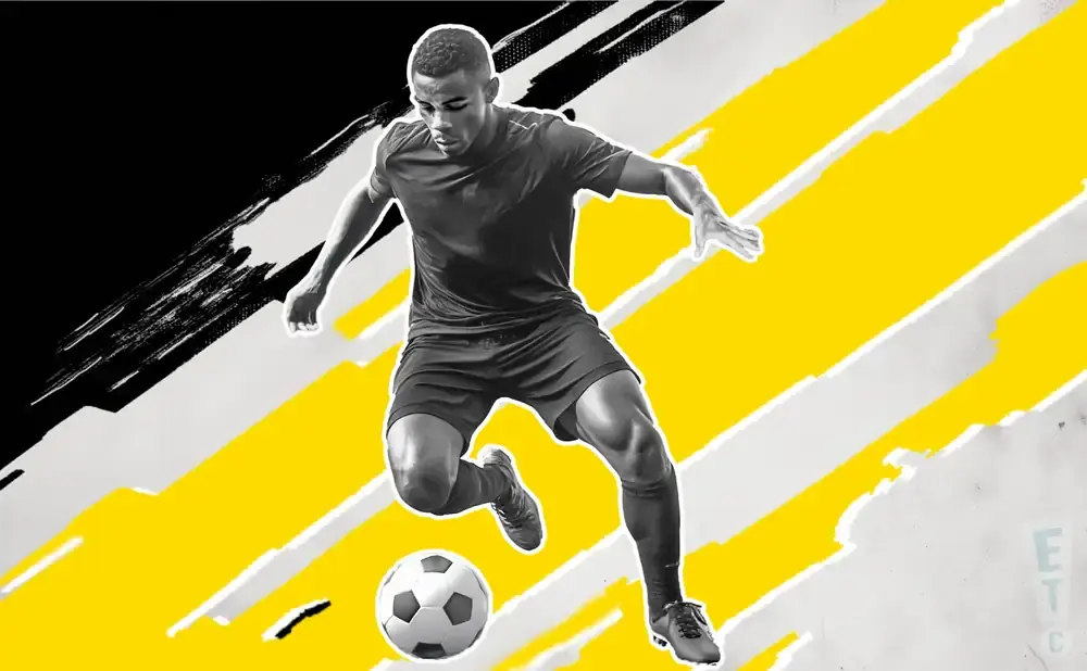 A Black soccer player in a black jersey and shorts dribbles a soccer ball against a bold yellow and black abstract background.
