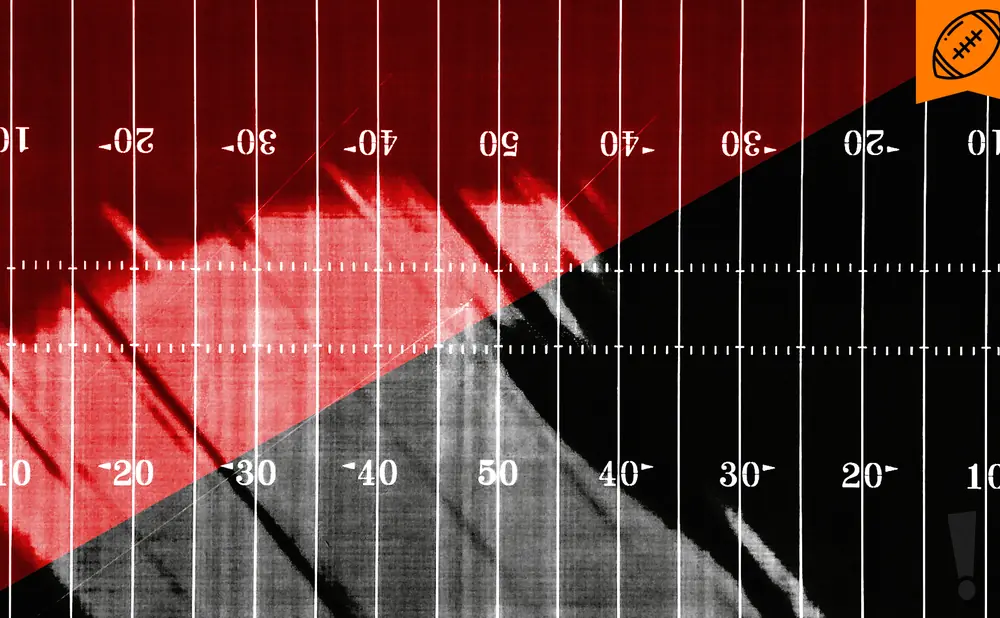 Football field with red and black halves, marked with yard lines and numbers.