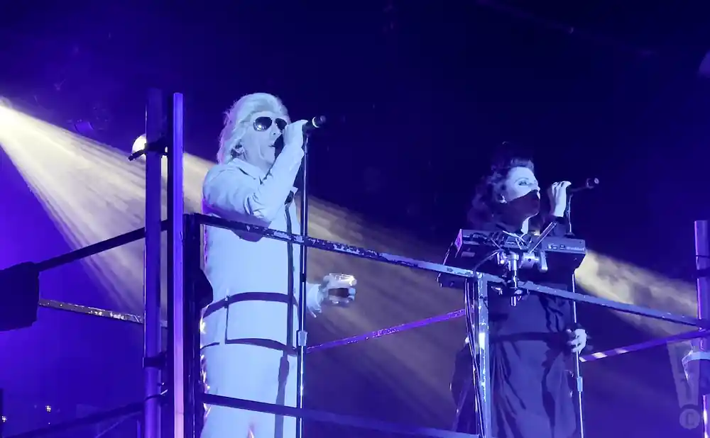 puscifer singers singing on a tall stage