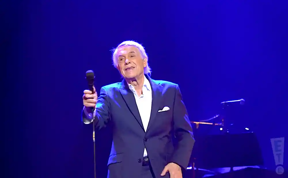 salvatore adamo singing live on stage in a suit in liège belgium
