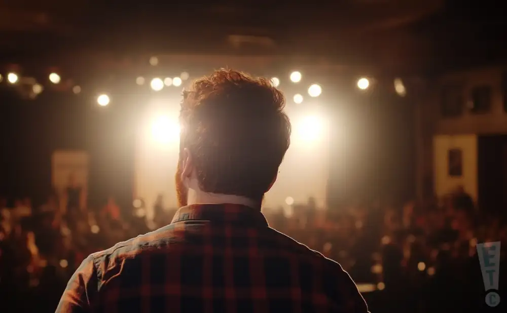a rear view picture of comedian billy anderson performing on stage
