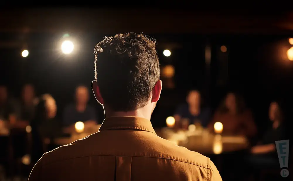 a rear view photo of comedian stuart thompson performing a comedy act on stage