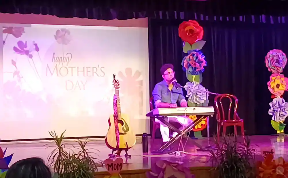 keyboardist performing at a mothers day celebration.