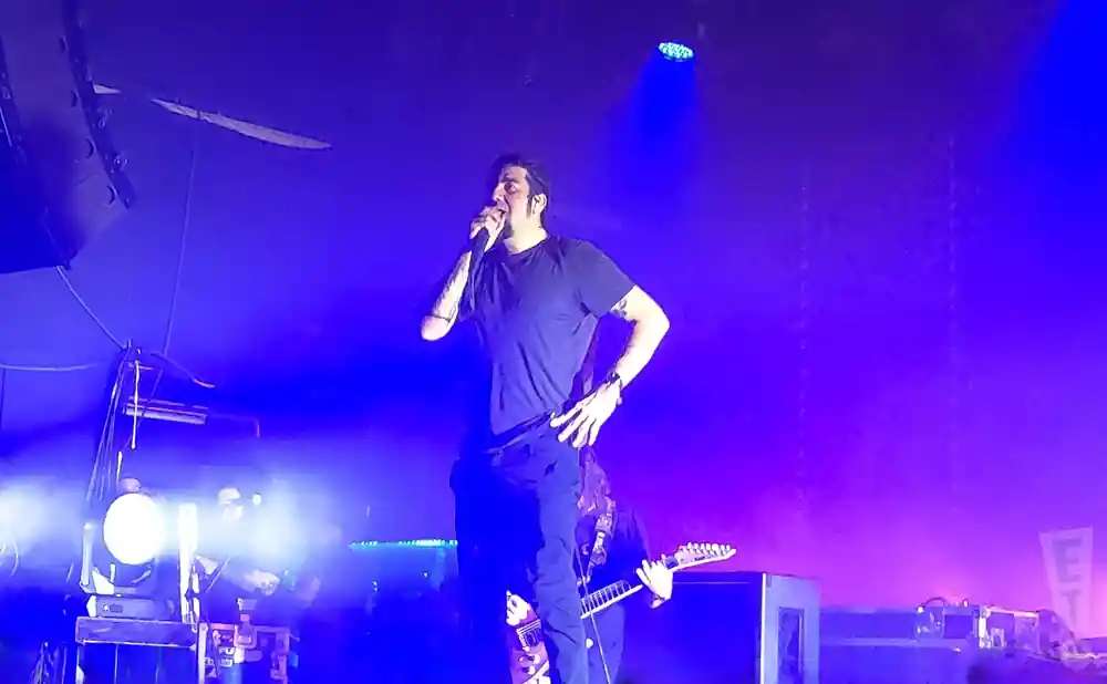 deftones singer singing in front of blue lights