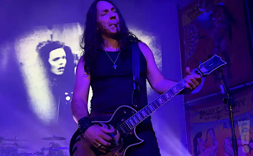 wasp electric guitarist playing live on stage