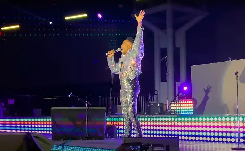 billy porter performing with his left arm raised